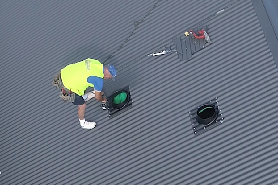 maxLoight Skylight Install worker on roof installing the flashing